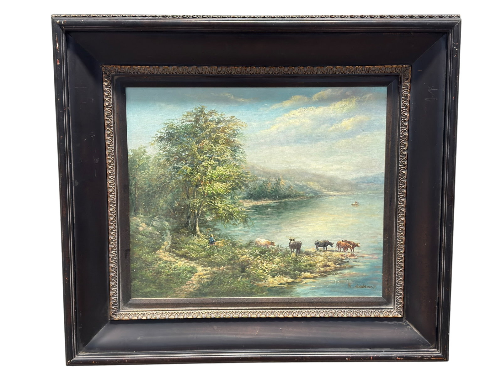 Signed R. Andrews Oil on Canvas Cattle & Lakeside Landscape Painting: A tranquil pastoral lakeside scene unfolds beneath a softly illuminated sky, with a small herd of cattle gathered along the water’s edge while a lone figure rests beneath the shade of a large tree a