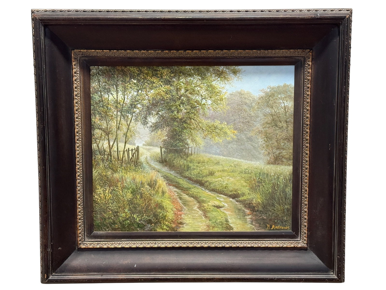 Signed R. Andrews Oil on Canvas Woodland Trail Landscape Painting: A softly illuminated country lane winds through a lush wooded landscape, drawing the eye deep into a hazy, atmospheric distance beneath a canopy of mature trees. The composition is especially appealin