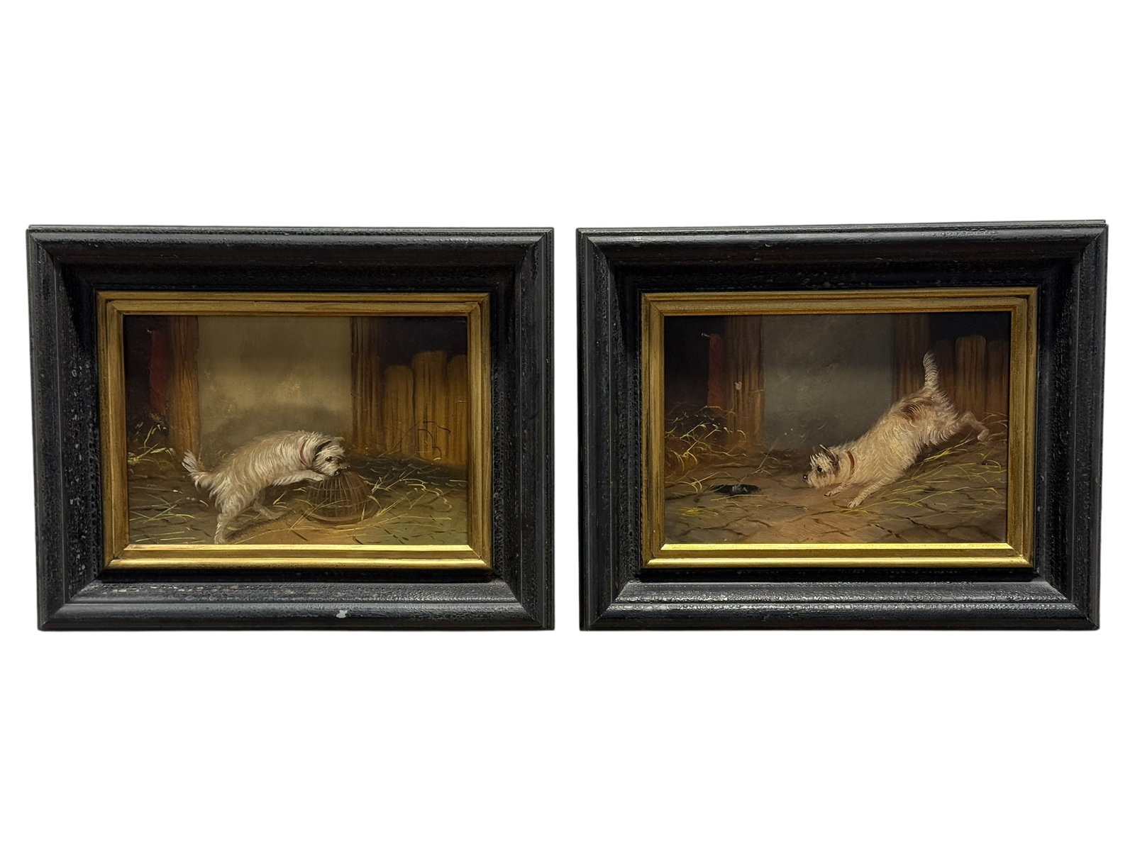 Pair of Early English Terrier Dog Paintings on Board: A charming and highly decorative pair of early English animal paintings captures a spirited terrier in two lively moments of pursuit, each scene set within a dim rustic stable or barn interior
