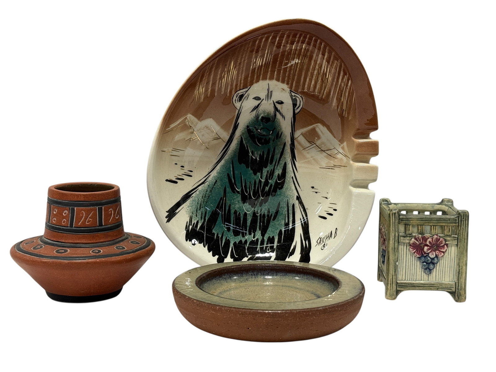 Group of Studio Pottery & Ceramic Decorative Art Pieces: Eclectic group of ceramic and studio pottery decorative pieces highlighted by a large sculptural platter or tray featuring a boldly painted polar bear against an Arctic landscape, signed “Sascha