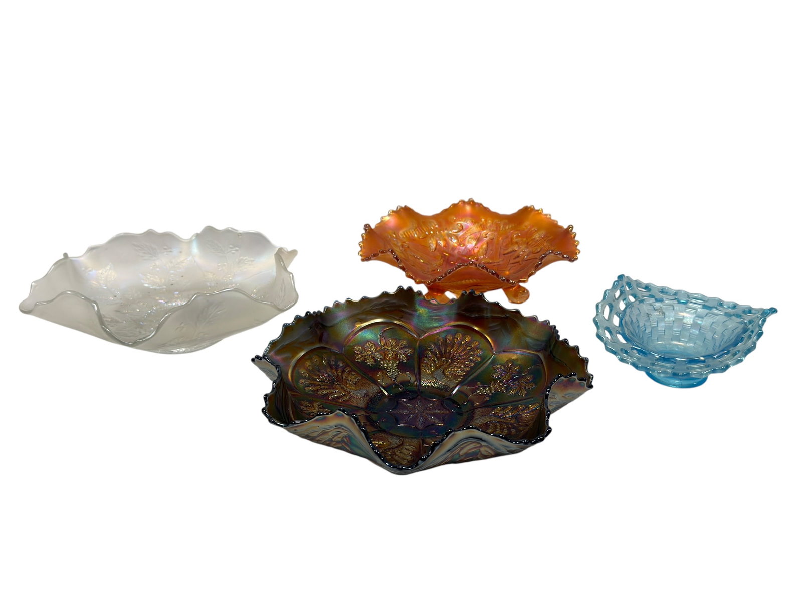 Group of 4 Fenton & Northwood Carnival Glass Bowls: Colorful group of four early American art glass and carnival glass pieces comprising a rare Fenton ice blue open-edge basket-form bowl with pierced lattice rim and woven basket pattern, a richly