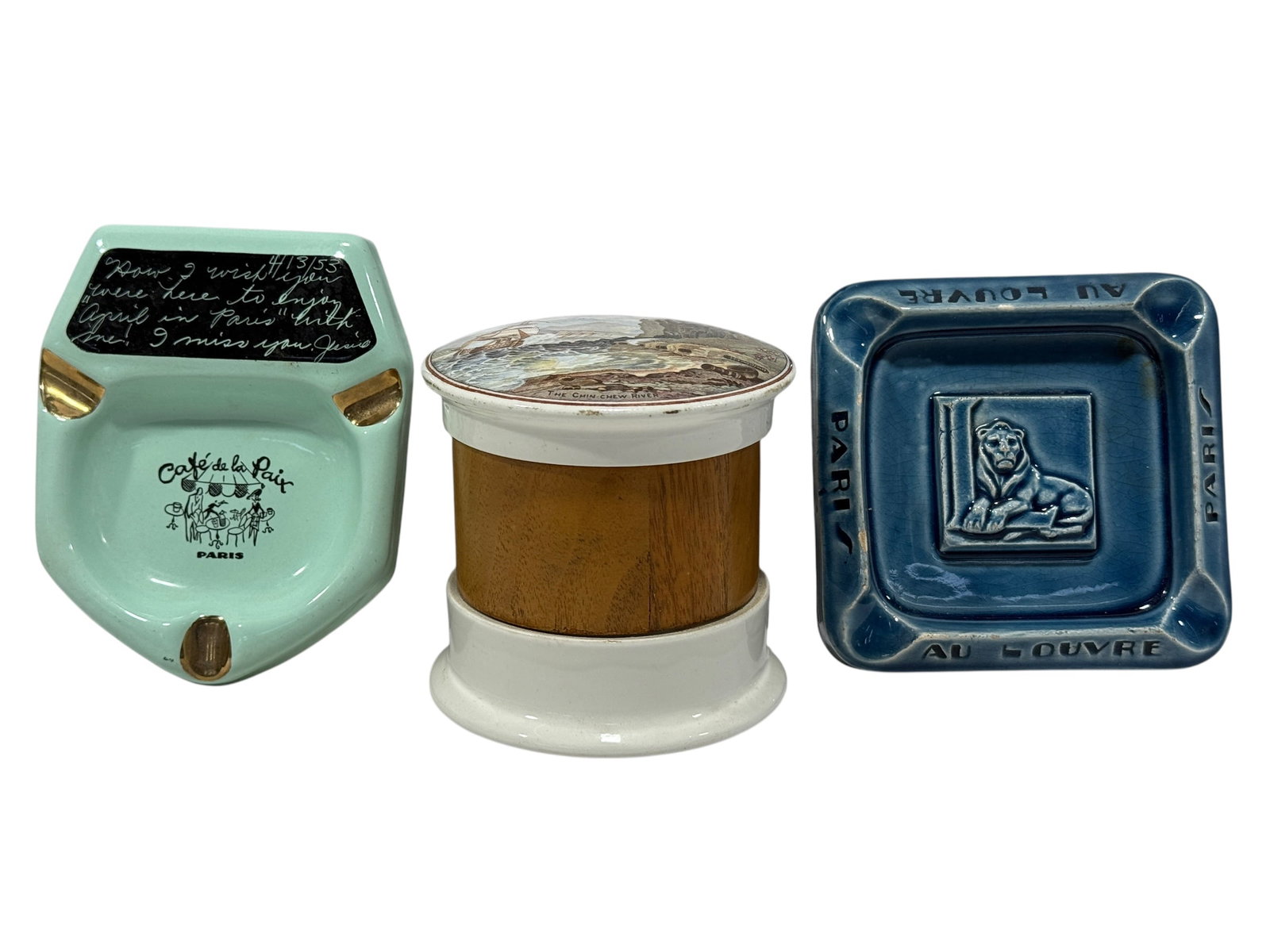 (2) Vintage Paris Souvenir Ashtrays & "The Chin Chew River" Tobacco Jar: Decorative group of three vintage smoking accessories comprising two ceramic ashtrays and a lidded tobacco jar. Included is a pale mint-green Café de la Paix, Paris ashtray with gilt cigarette rests 