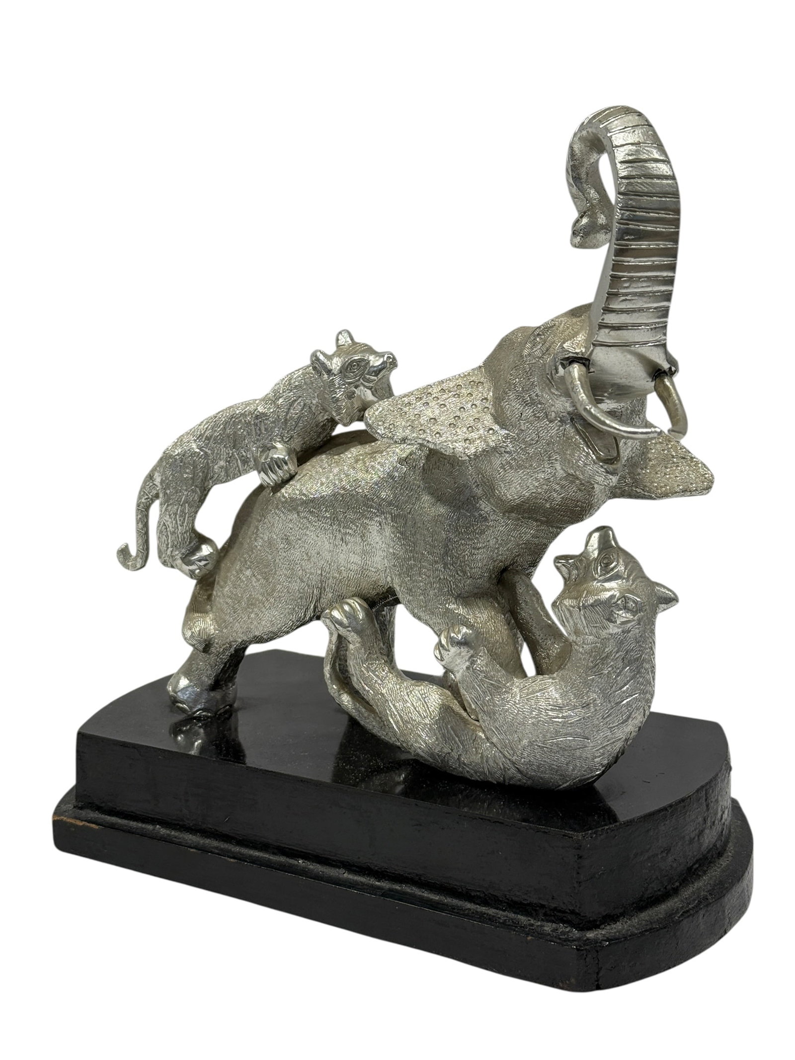 Silvered Brass Elephant & Tigers Figural Sculpture on Wood Base: Decorative silvered brass animal sculpture depicting a dramatic elephant under attack by two tigers, one climbing across the elephant’s back and the other positioned beneath its front body. The elep