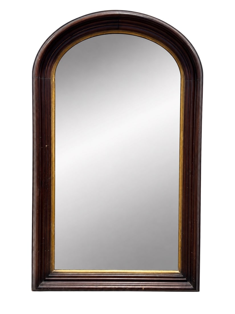 19th Century Mahogany Arched Wall Mirror with Gilt Liner: A handsome antique 19th century wall mirror featuring a tall architectural form with a gracefully rounded arched crest, framed in richly toned mahogany with deep molded contours and a contrasting gilt