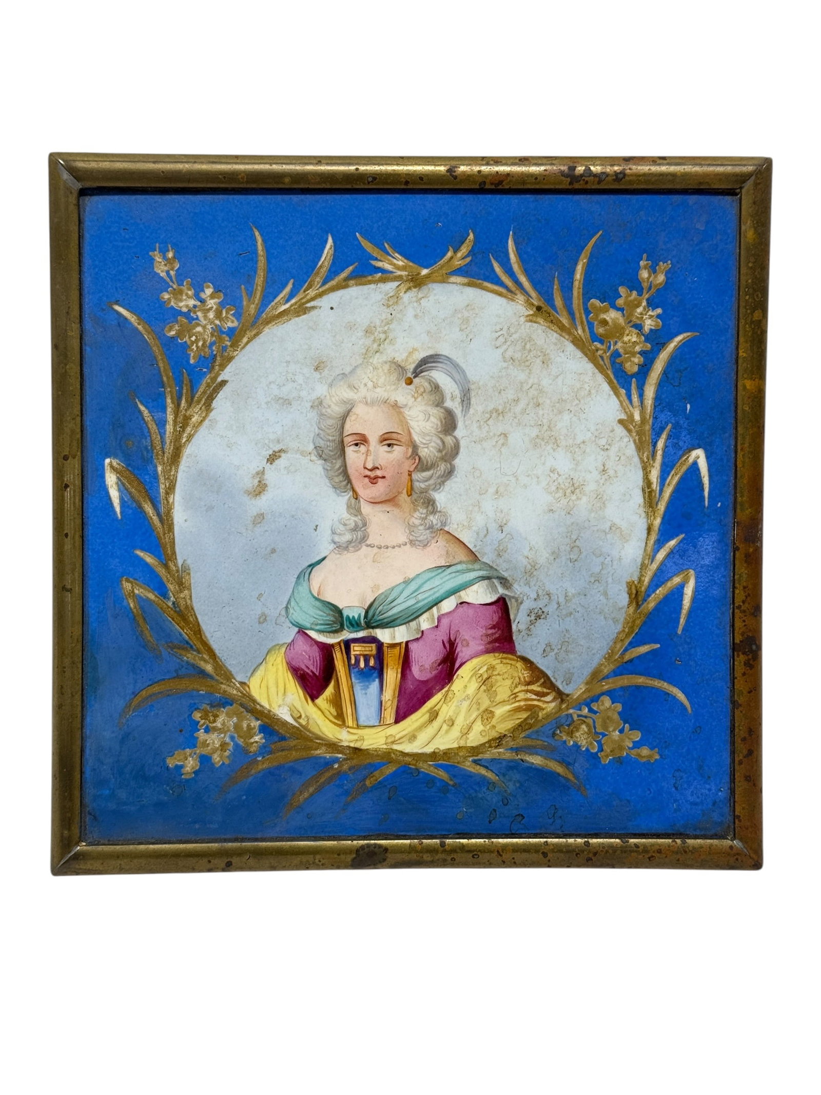 Antique Hand-Painted Porcelain Portrait Trivet with Brass Frame: The piece features a hand-painted porcelain tile depicting an elegantly dressed lady in 18th-century costume, set against a vivid cobalt-blue ground and surrounded by gilt floral and foliate