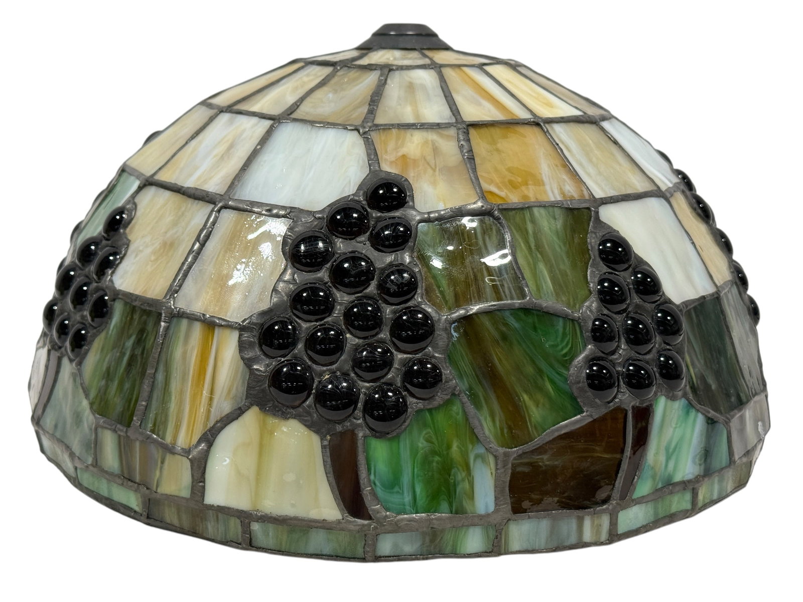 Tiffany Style Grape Motif Leaded Stained Glass Lamp Shade: Decorative Tiffany style leaded stained glass lamp shade featuring a domed form with a repeating grapevine motif worked in richly mottled cream, pale amber, green, and white glass. Clusters of dark gl