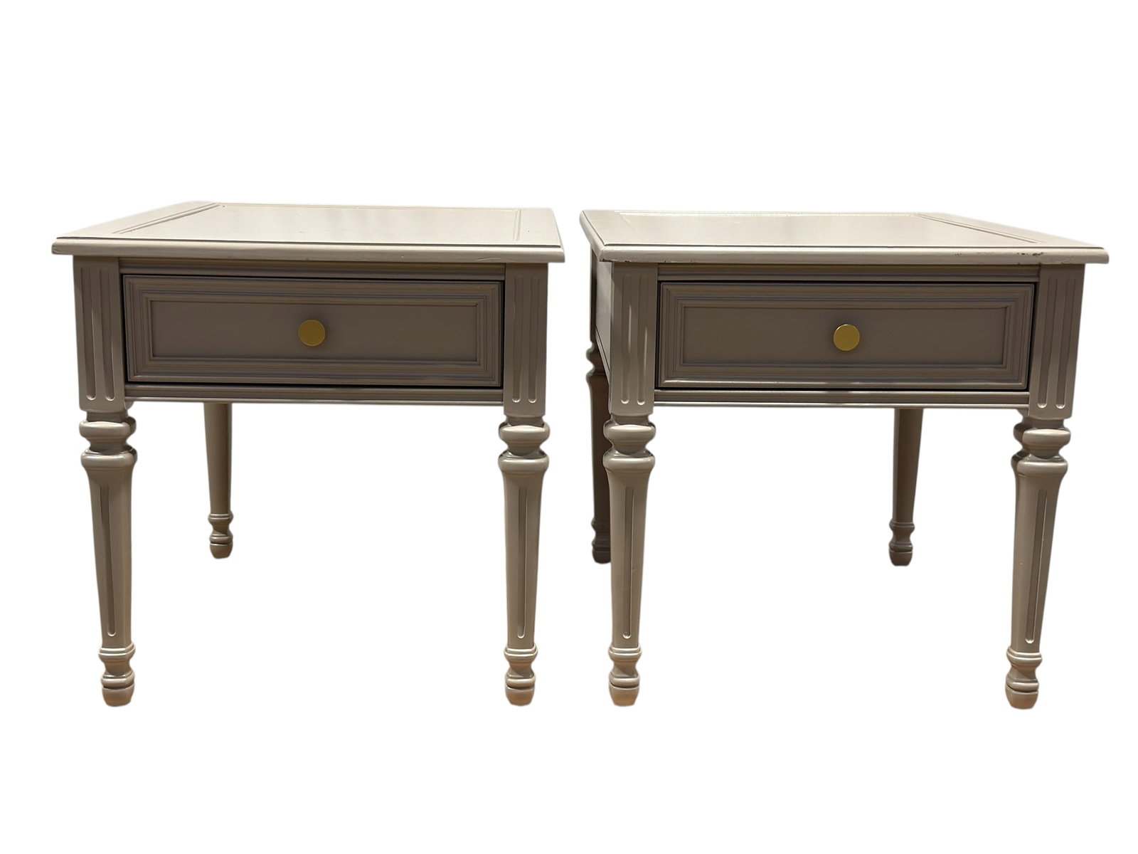 Pair of Louis XVI Style Painted Side Tables: Pair of coordinating Louis XVI-style side or end tables, each finished in a soft pale gray painted surface and constructed with a square molded top centered by an inset rectangular panel, a single fri