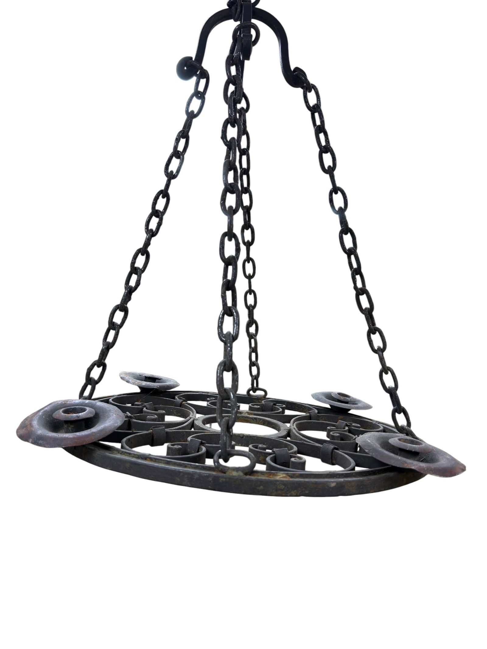Antique Wrought Iron Hanging Chandelier: Substantial antique hanging chandelier constructed of heavy wrought iron, featuring an elongated oval frame enriched with scrolling ironwork and multiple raised circular candle platforms arranged arou