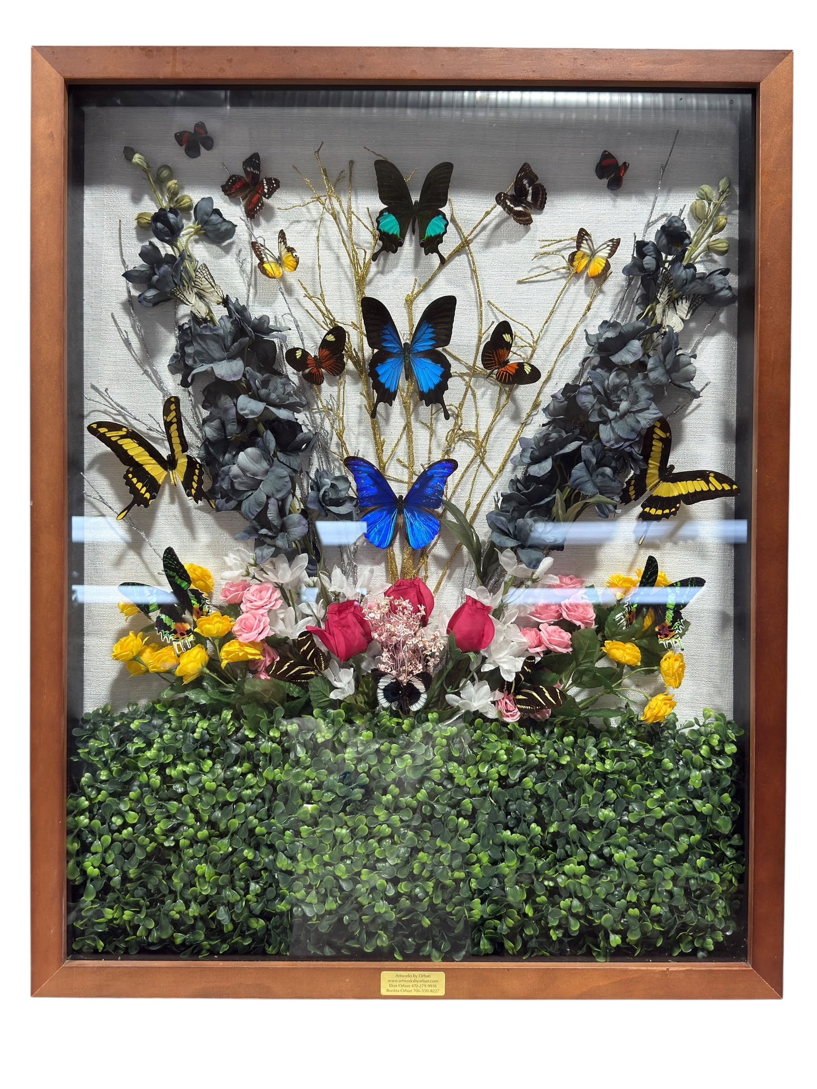 Large Framed Butterfly Specimen Floral Garden Shadow Box Display: Large decorative shadow box featuring an elaborate arrangement of 18 mounted butterfly specimens displayed among faux flowers, leafy greenery, and branching botanical elements. The composition is