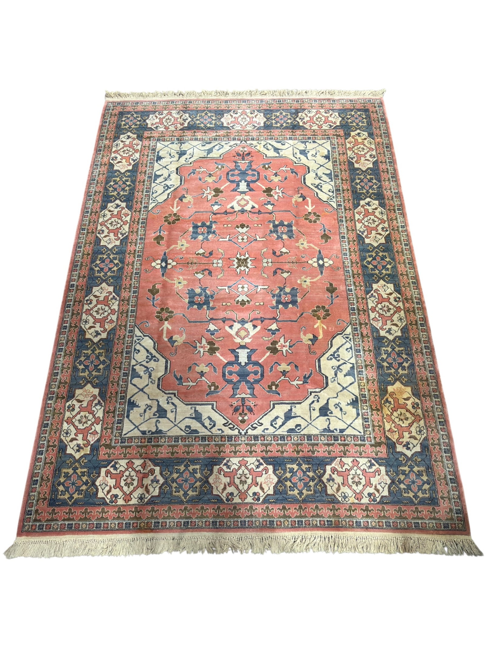 Karastan Bergama Design Wool Area Rug: Traditional Karastan area rug in the Bergama Design, featuring a large rose-pink central medallion surrounded by ivory spandrels and a deep blue floral border with geometric and stylized botanical mot