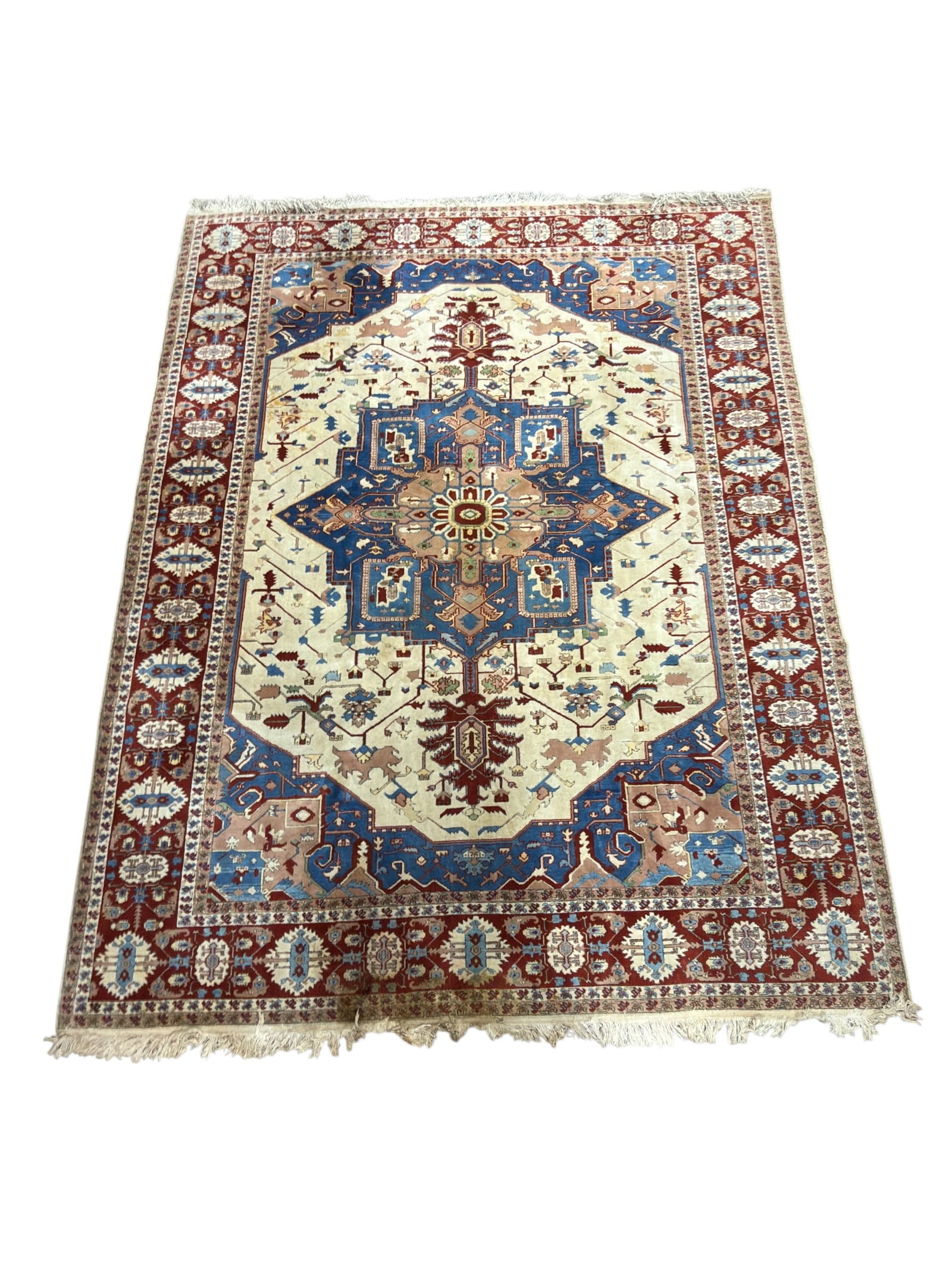 Turkish Wool Heriz-Style Area Rug: Large Turkish wool area rug featuring a bold Heriz-inspired geometric medallion design in ivory, blue, burgundy, rose, and muted tan tones. The field is centered by a large angular medallion with styl