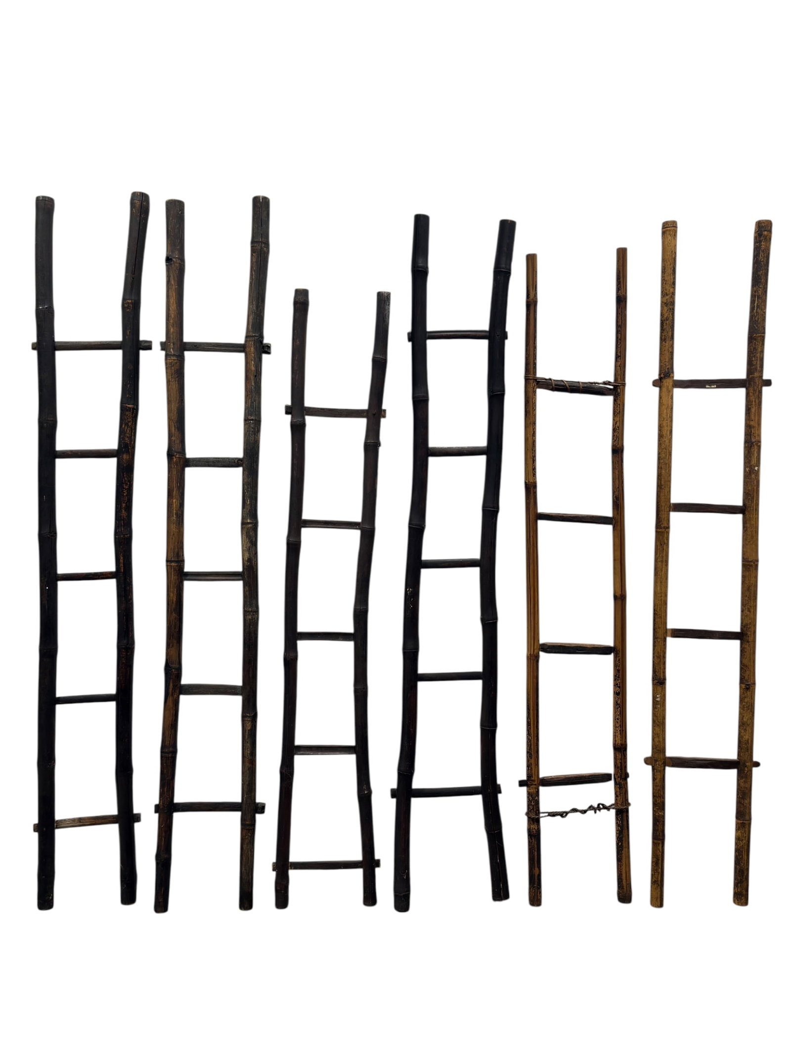 (6) Rustic Bamboo Ladders, 20th Century: Set of six tall 20th-century rustic bamboo ladders, each constructed from naturally segmented bamboo uprights fitted with simple horizontal bamboo or wooden rungs. The group displays appealing variati