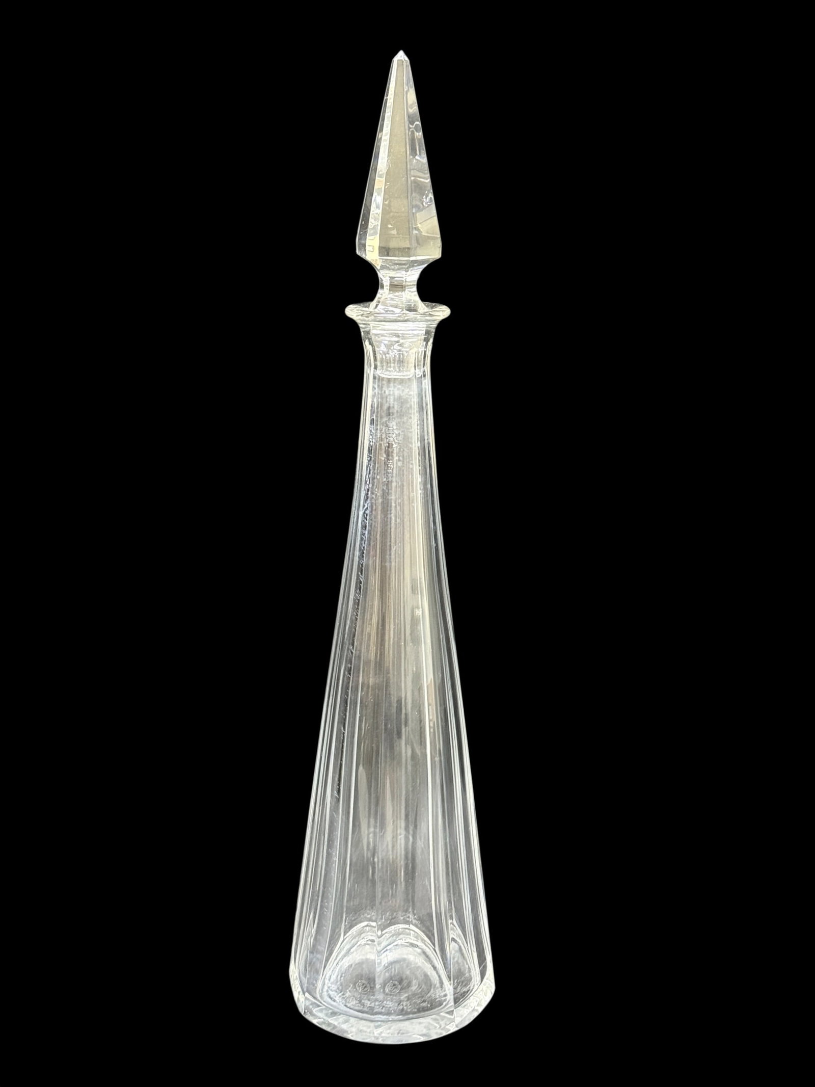 Baccarat France Crystal Decanter with Faceted Obelisk Stopper: Elegant Baccarat France clear crystal decanter with a tall, slender tapered body cut with elongated vertical facets and fitted with a dramatic faceted obelisk-form crystal stopper. Both the decanter a