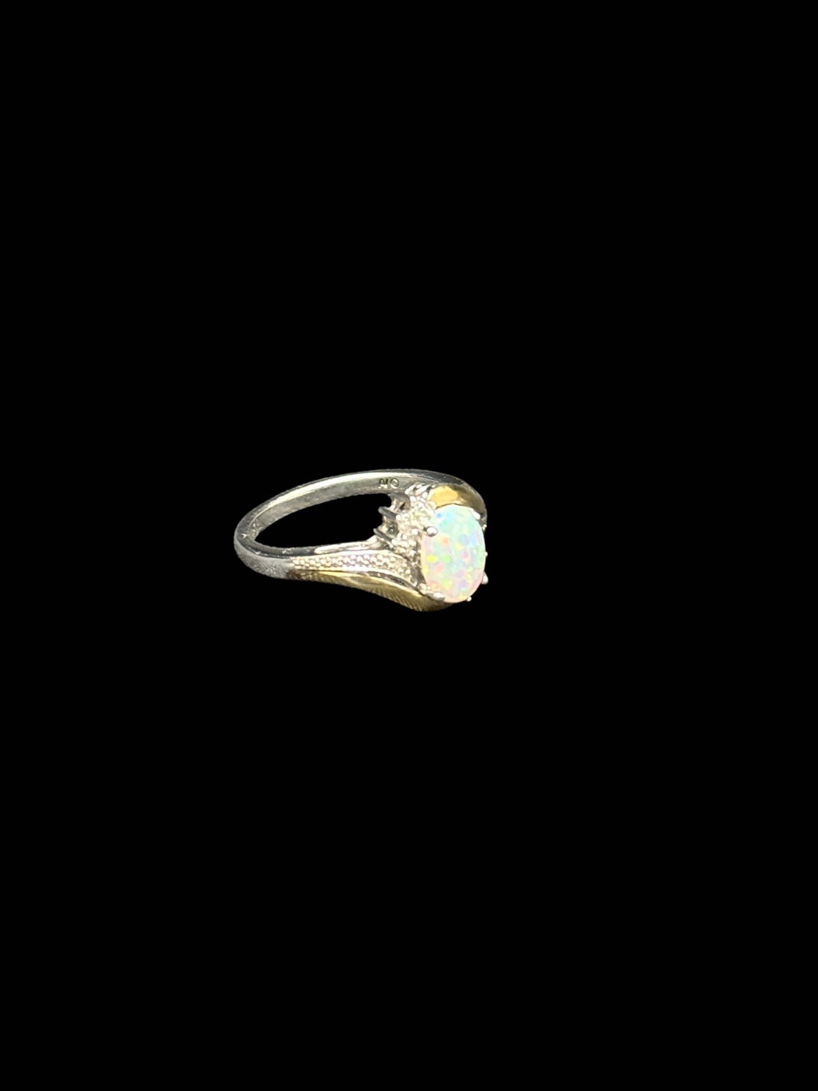 Sterling Silver, Gold Accent, Opal & Diamond Ring: Decorative sterling silver ring centered by an oval cabochon opal displaying strong multicolor play-of-color with flashes of green, red, orange, and blue. The opal is framed by small accent stones app