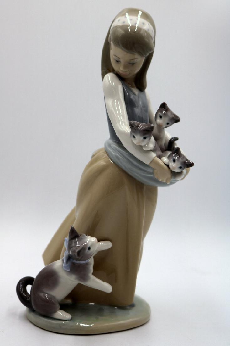 Lladro "Following Her Cats" #1309 Porcelain Group: Lladro "Following Her Cats" #1309 Porcelain Group. Measures - 9 1/2" High.