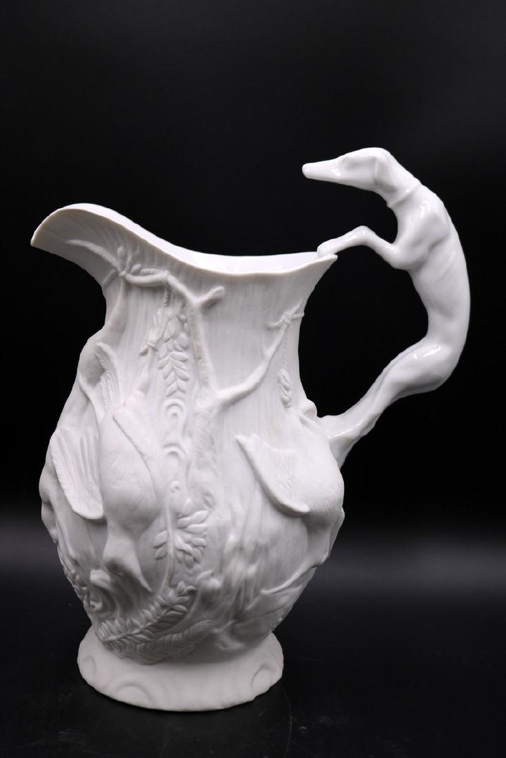 Mottahedeh Vista Alegre Bisque Porcelain Figural: Mottahedeh Vista Alegre Bisque Porcelain Figural Pitcher. Mark on bottom. Measures - 11 1/4" high x 9 1/4" wide. Greyhound dog handle. Bird and floral design.