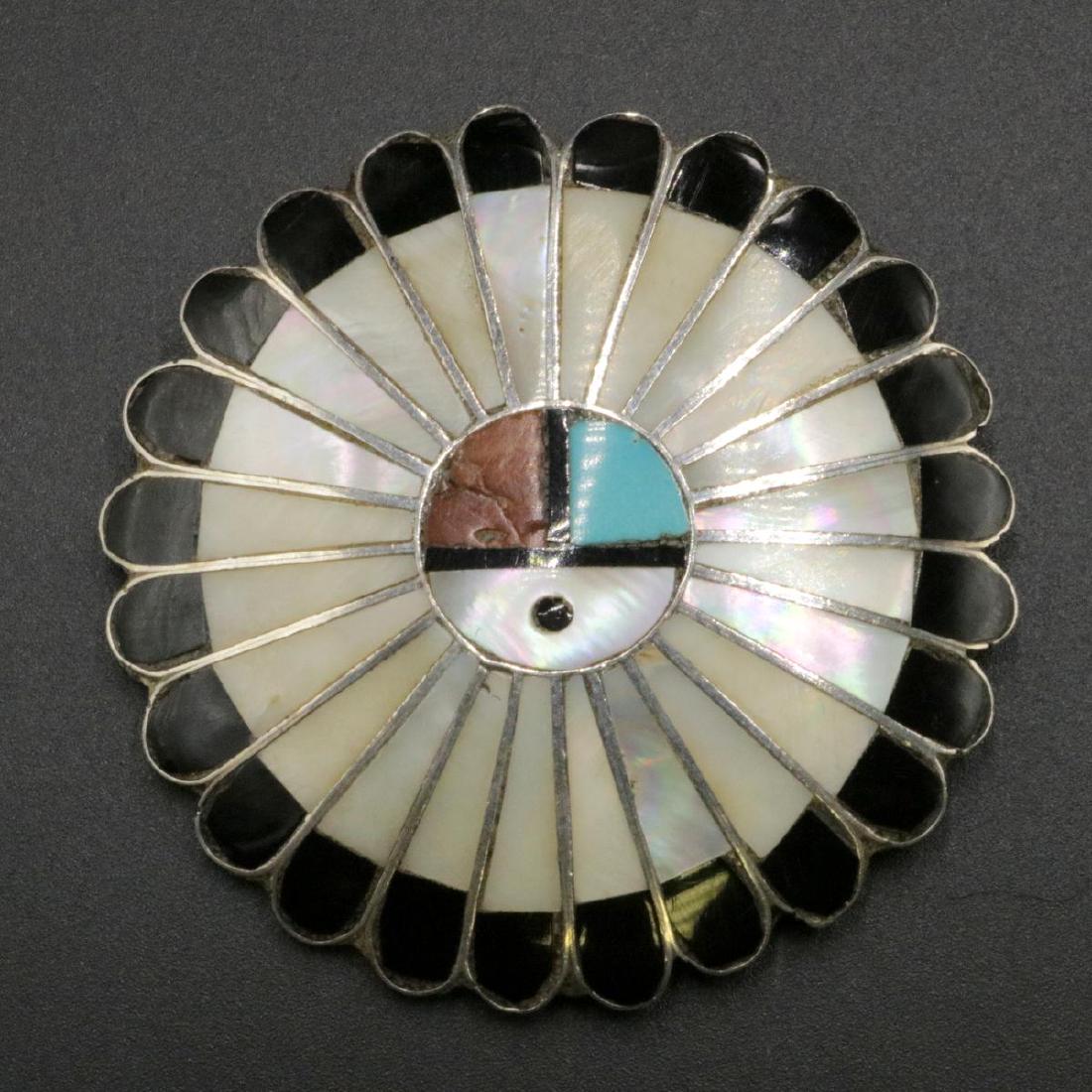 Native American Sterling & Inlaid Brooch: Navajo Native American Sterling Silver & Inlaid Mother of Pearl, Turquoise, Coral & Black Onyx Brooch. Measures - 2" diameter. Weight - 17.3 grams.
