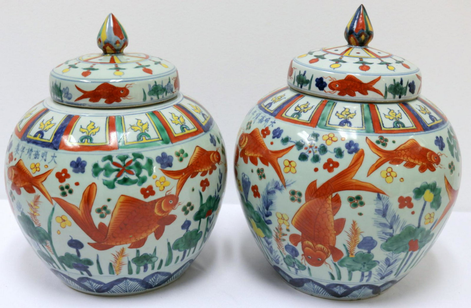 Chinese Hand Painted Porcelain Covered Jars: Chinese Hand Painted Porcelain Covered Jars. Signed on vase. Depicting floral and koi fish design. Measures - 13" high x 10" diameter.