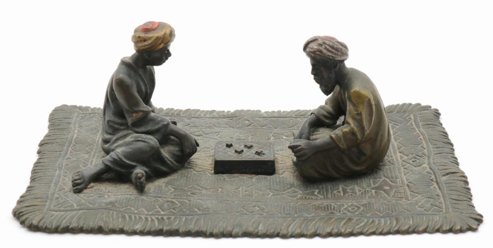 After Franz Bergmann Austrian Bronze Sculpture: After Franz Xaver Bergmann (Bergman) Austrian Cold Painted Bronze Sculpture. Depicting a seated men on carpet playing a board game. Measures - 2" high x 4 3/4" long.