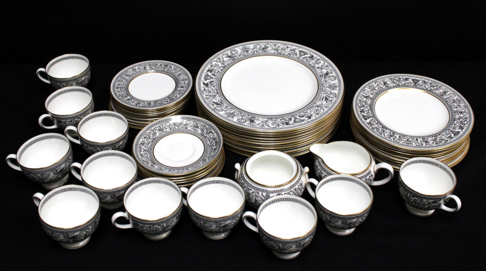 57 Pc. Wedgwood "Florentine" Black China Set: 57 Pc. Wedgwood "Florentine" Black (Black Dragons) China Set. This set contains 12 dinner plates, 12 salad plates, 12 bread and butter plates, 11 tea cups, 8 saucers, 1 creamer and 1 sugar. Sugar is m