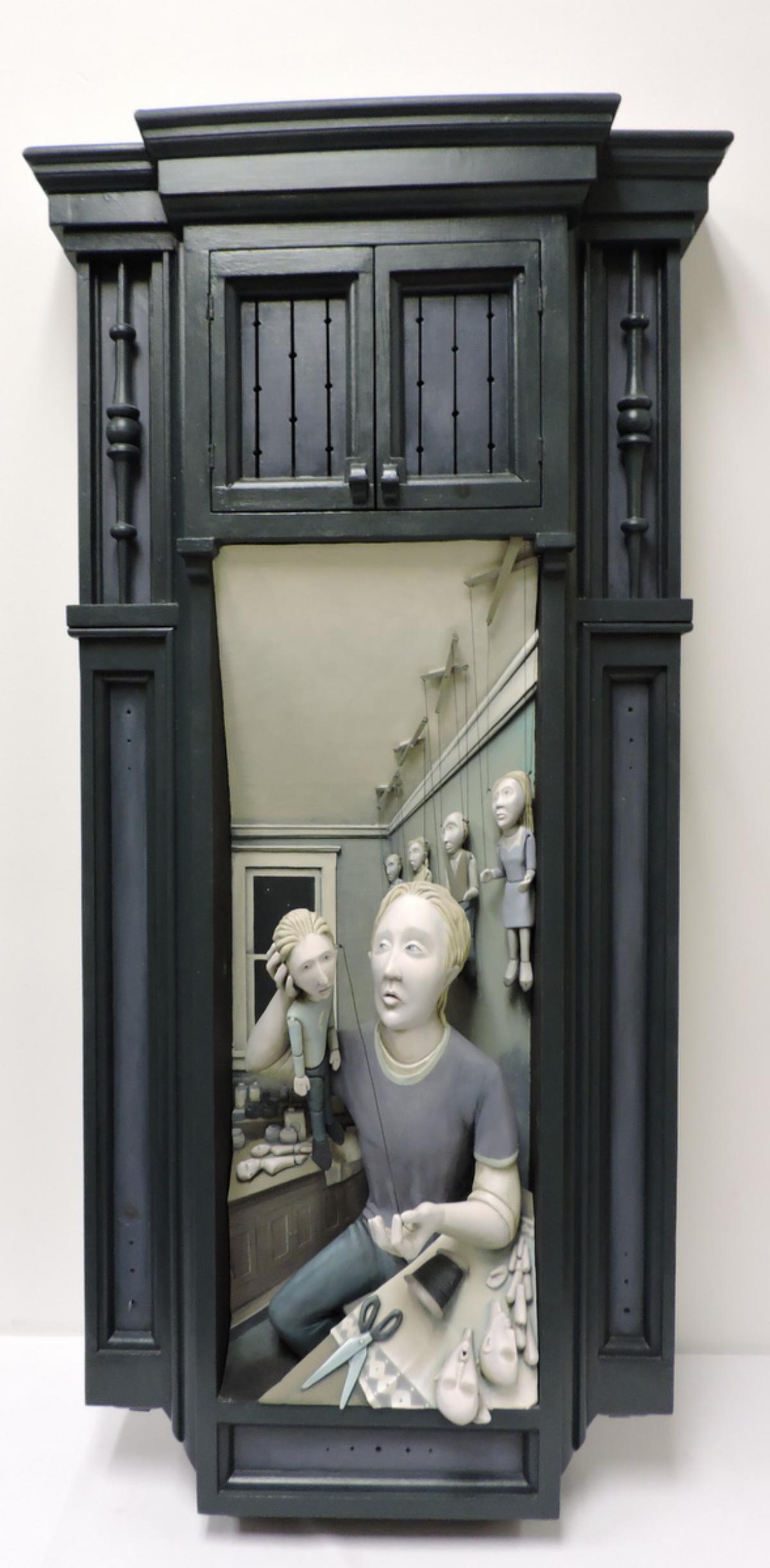 Kevin Hanna (b. 1978) "Time Alone" Wall Hanging: Kevin Hanna (b. 1978) "Time Alone" Mixed Media Wooden Three-Dimensional Wall Hanging. Dated 1997. Depicting a person making puppets. Measures - 49" high x 24 1/2" wide x 7" deep.