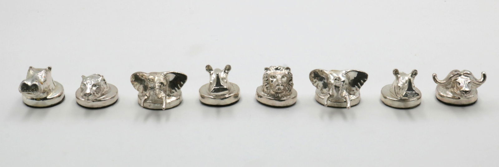8 DG Animal Sterling Place Card Holders: 8 Pc. Signed DG Animal Sterling Silver Overlay Place Card Holders. Depicting a jaguar, elephant, water buffalo, rhino, lion and hippo. Measures - 1 1/4" high.