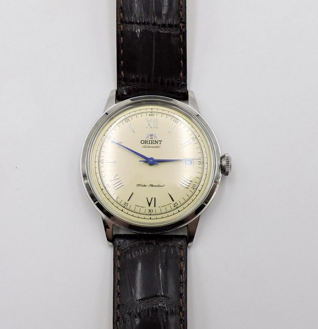 Orient Automatic General Bambino Watch: Orient Automatic General Bambino Watch. With leather band. Measures - 9 3/4" long.