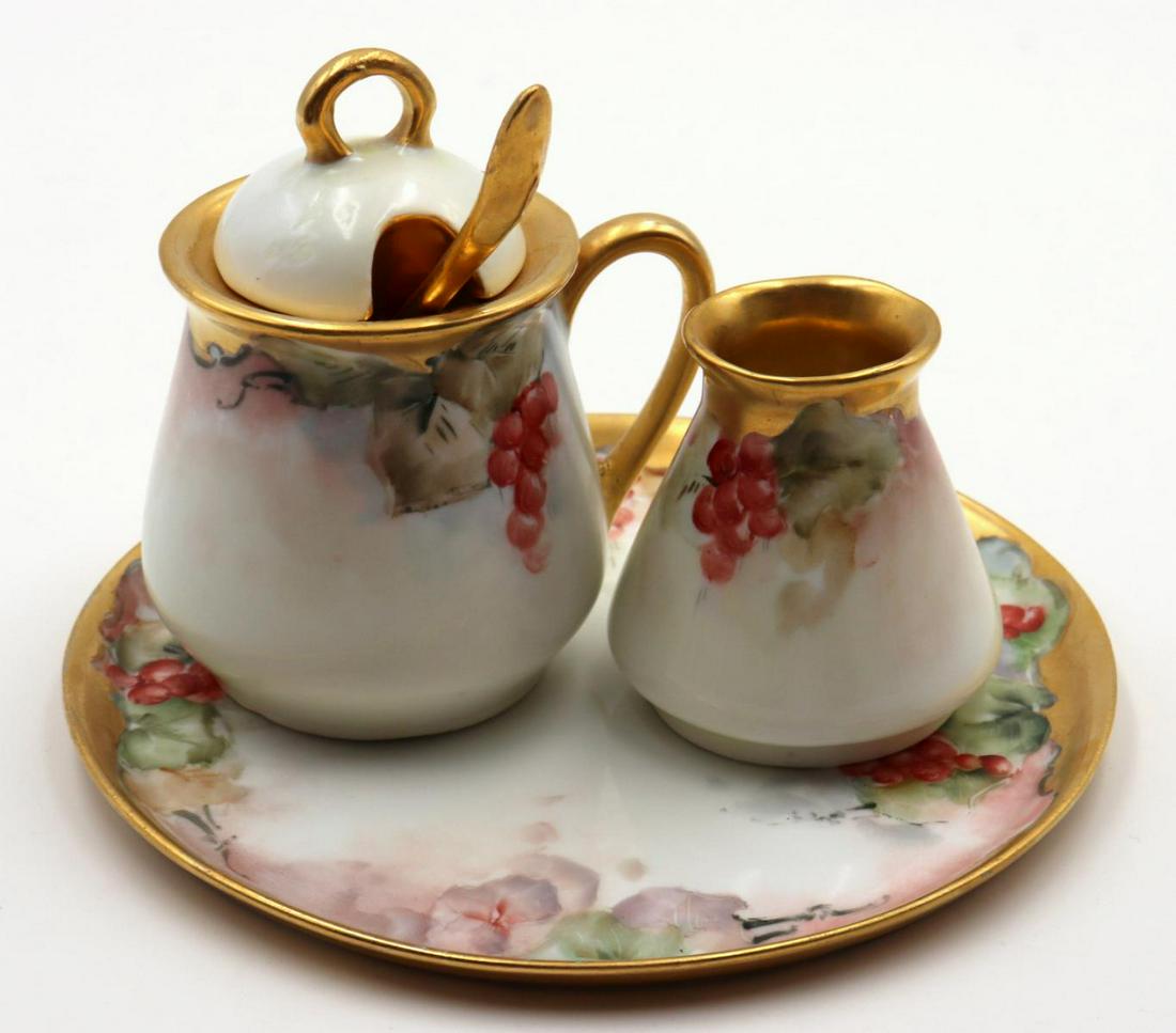 Antique Limoges Porcelain Sugar & Creamer Set: Antique Limoges Porcelain Sugar & Creamer Set. Tray - 6" diameter, creamer - 2 1/2" high, spoon - 4 1/2" long, covered sugar - 4" high.