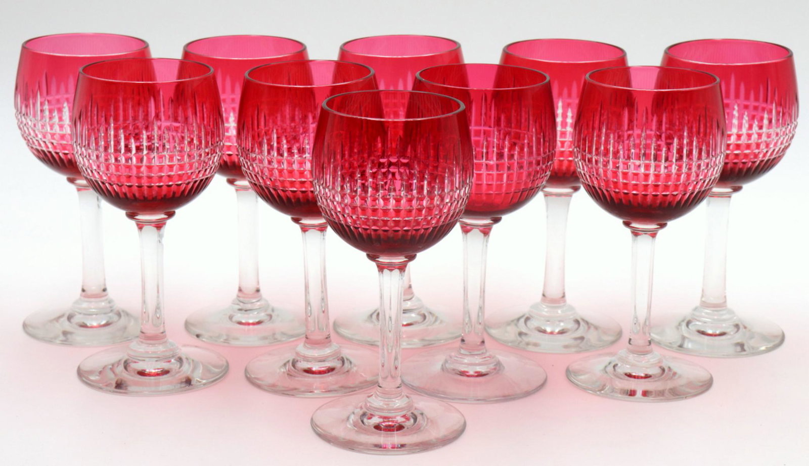 10 Baccarat "Nancy" Ruby Crystal Claret Wines: 10 Pc. Baccarat "Nancy" Ruby Crystal Claret Wine Glasses. Measures approx. - 5 1/4" high. Please note - two glasses have a chip on bottom.