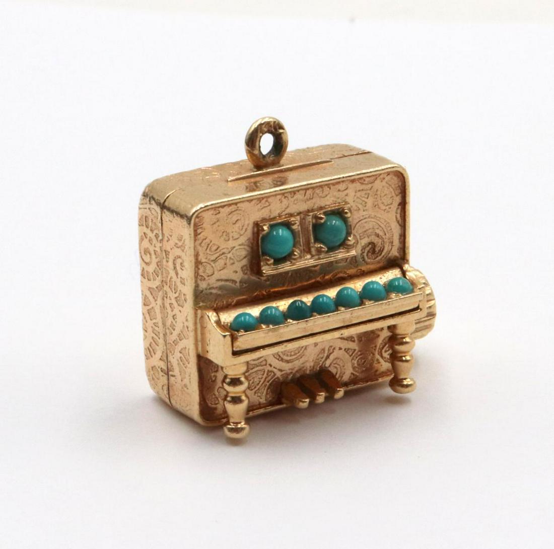 14Kt "Musical Piano" Piano Charm: 14Kt "Musical Piano" Piano Charm. With turquoise keys. Weight - 12.3 dwt.