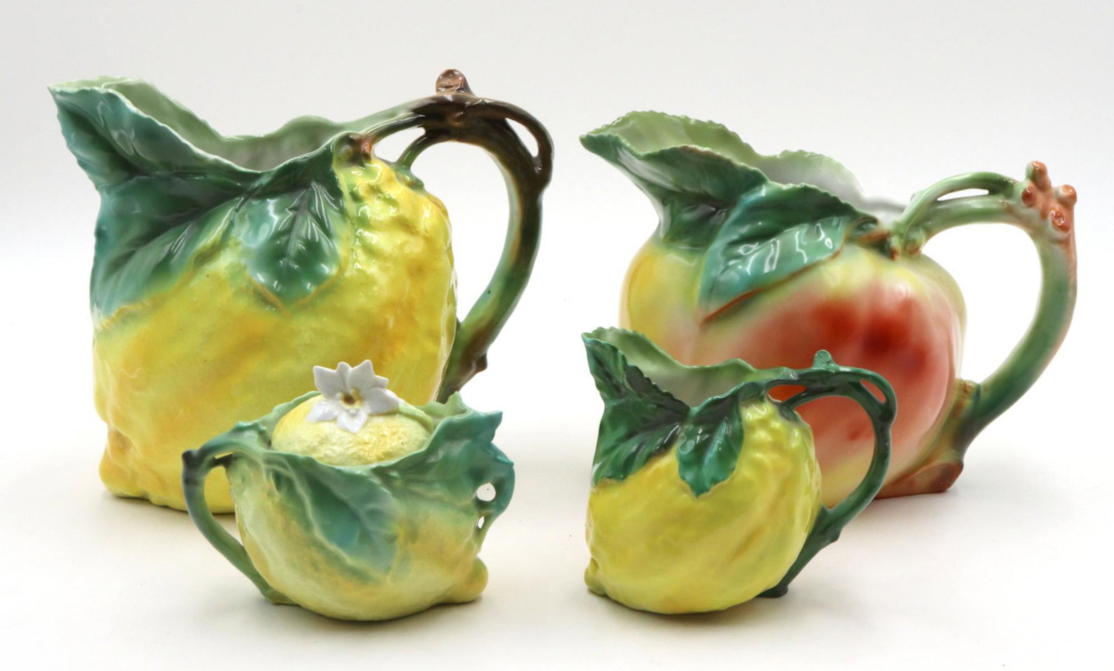 Royal Bayreuth "Lemon" Porcelain Group: Royal Bayreuth "Lemon" Porcelain Group. Water pitcher - 6 3/4" high, pitcher - 5 3/4" high, creamer - 3 3/4" high, covered sugar - 3 3/4" high. All are marked.