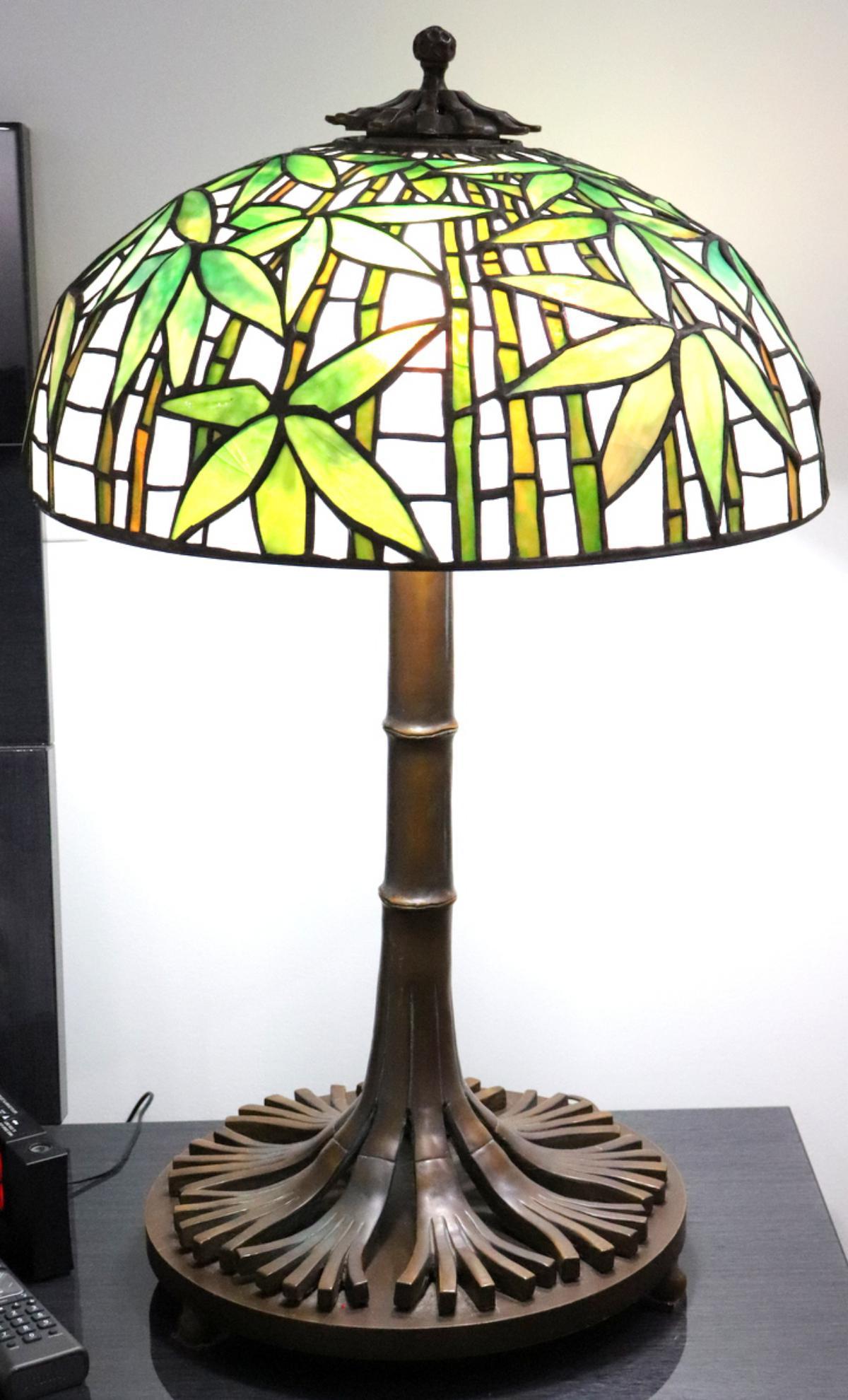 After Tiffany Studios "Bamboo" Glass & Bronze Lamp: After Tiffany Studios "Bamboo" Stained Glass & Bronze Lamp. In bamboo style. Measures approx. - 30" high x 19" diameter. Shade is as is, there is a couple of cracked glass pieces, one glass piece has 