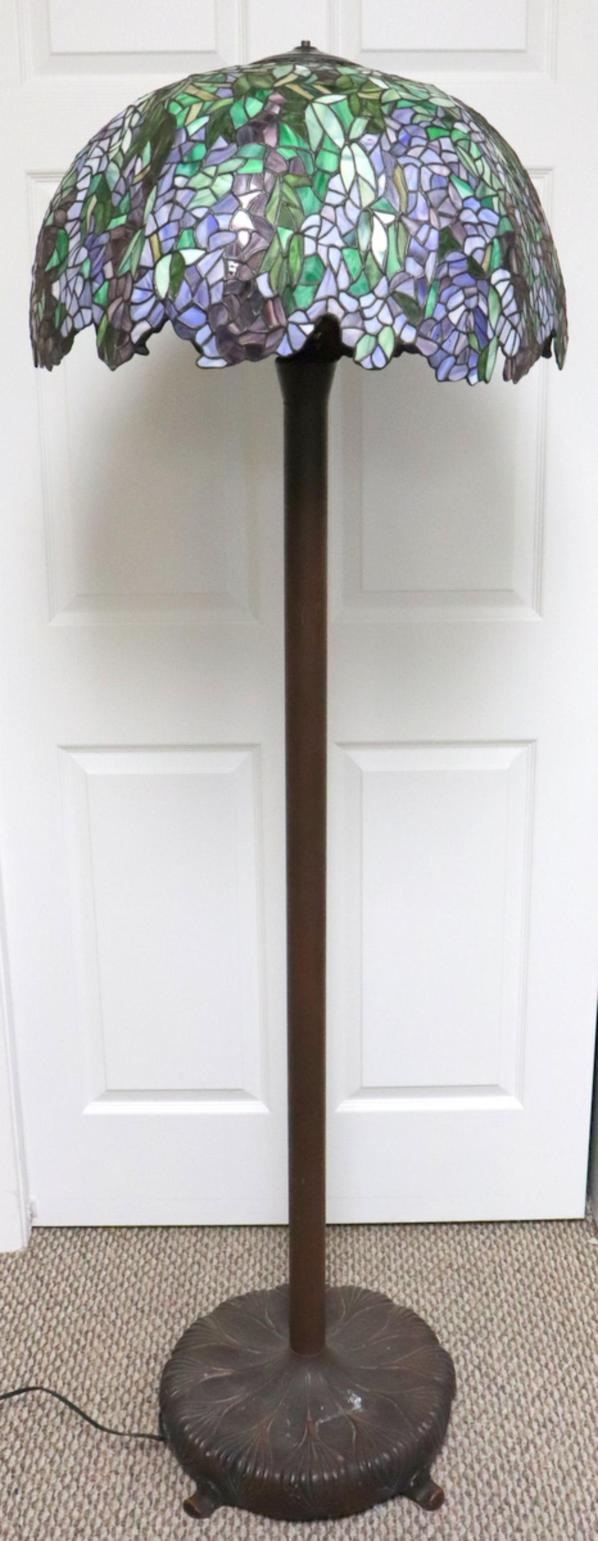 After Tiffany Stained Glass & Bronze Floor Lamp: After Tiffany Stained Glass & Bronze Floor Lamp. Measures approx. - 68" high x 23" diameter.