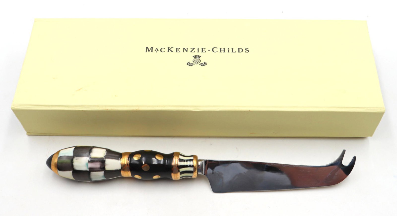 MacKenzie Childs Checkered Cheese Knife: MacKenzie Childs Checkered Cheese Knife. With original box. Measures approx. - 8 3/8" long.