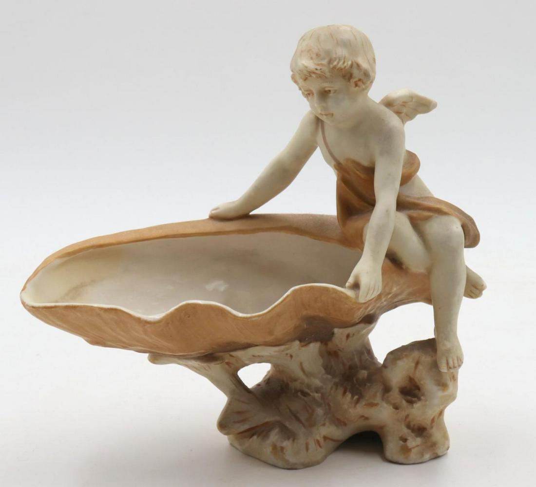 Royal Dux Cherub Porcelain Vide Poche: Royal Dux Cherub Porcelain Vide Poche. Measures approx. - 7" high x 7" long.