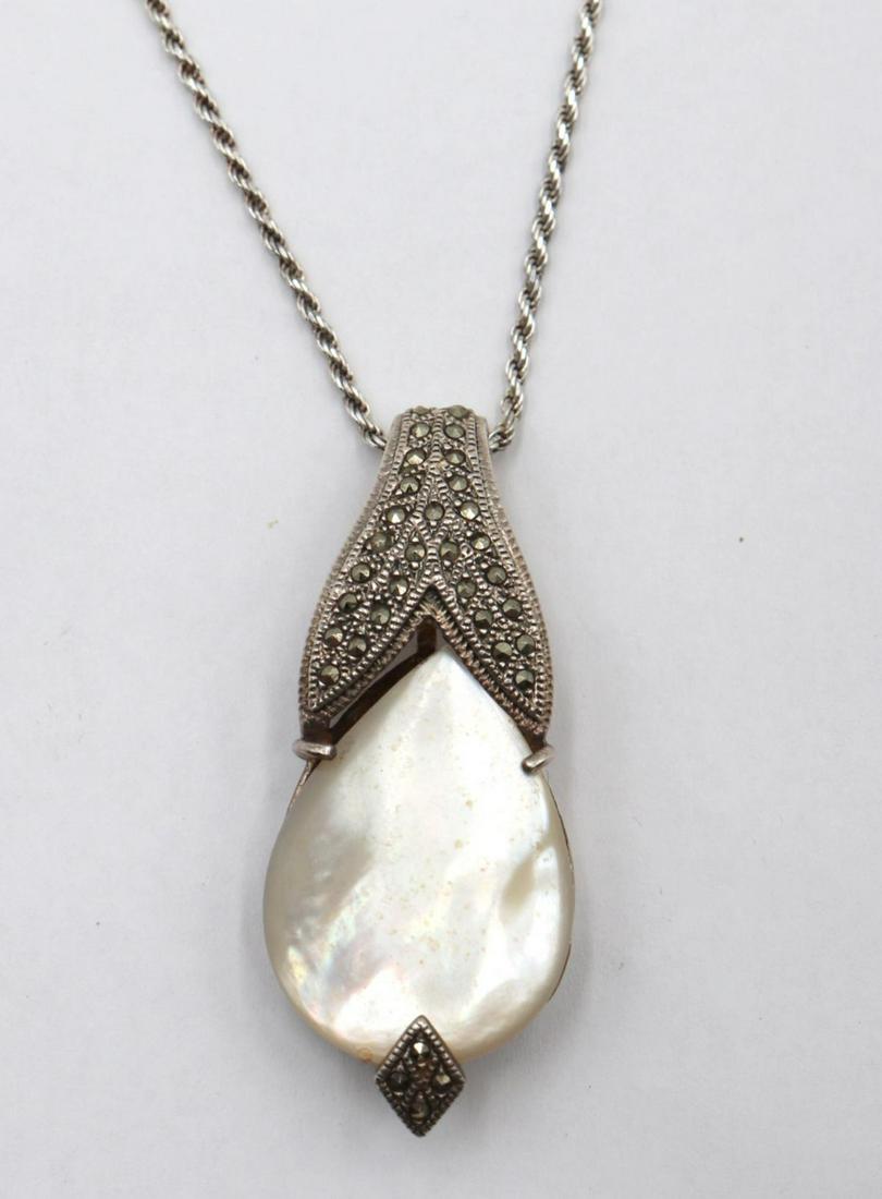 Sterling MOP & Marcasite Pendant w/ Necklace: Sterling Silver Mother of Pearl & Marcasite Pendant w/ Necklace. Measures approx. - 17" long. Weight - 18.5 grams.