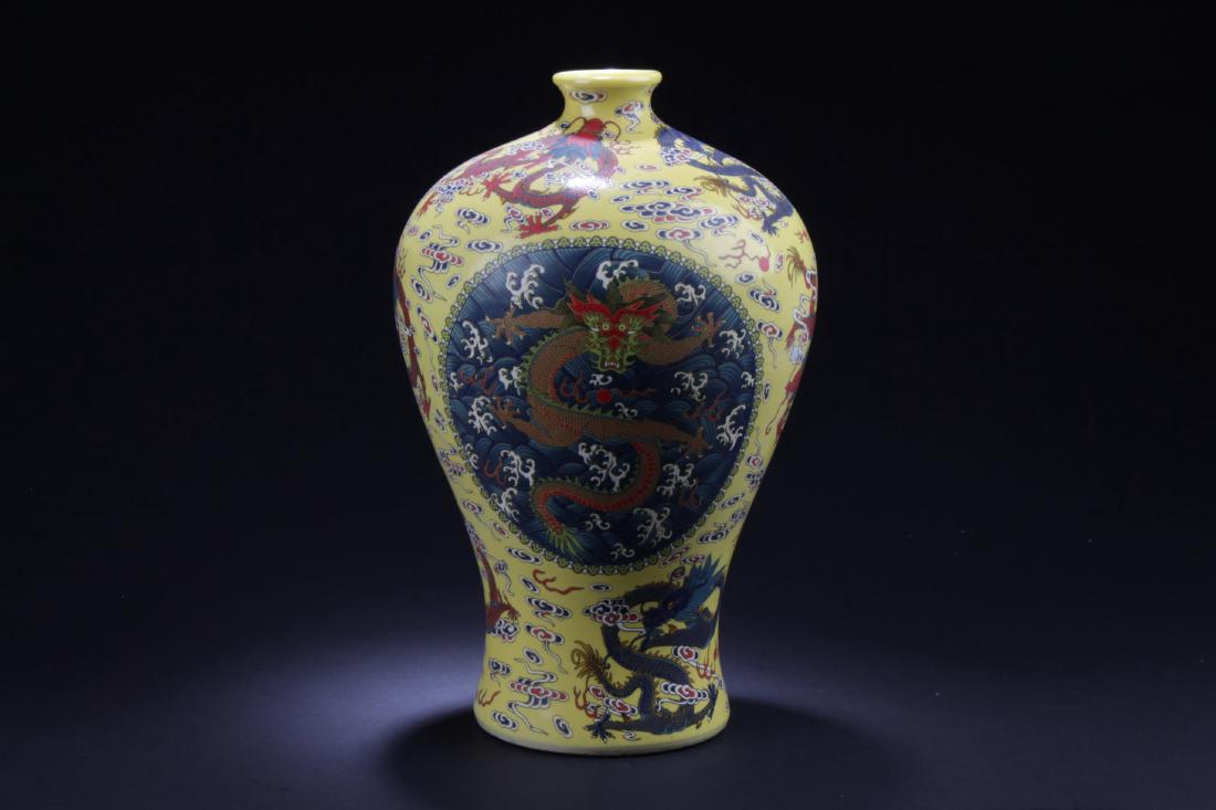 Chinese Famille Jaune Meiping Vase: The porcelain vase is pinated with five-clawed dragons surrounded by scrolling clouds. 'YongZheng' character mark. Height: 14.75 "