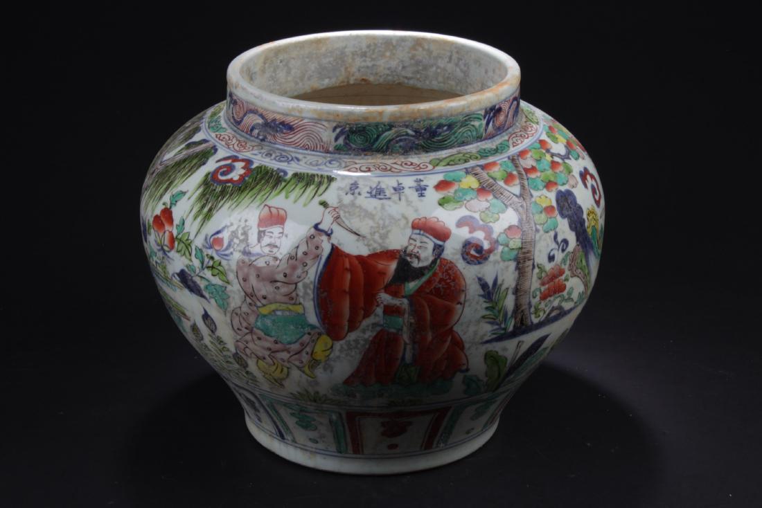 Chinese Wucai Porcelain Jar: Of broad shoulders and rising to a short neck, the porcelain jar is decorated with narrative scene of men and warriors in outdoor scenery. Height: 12"