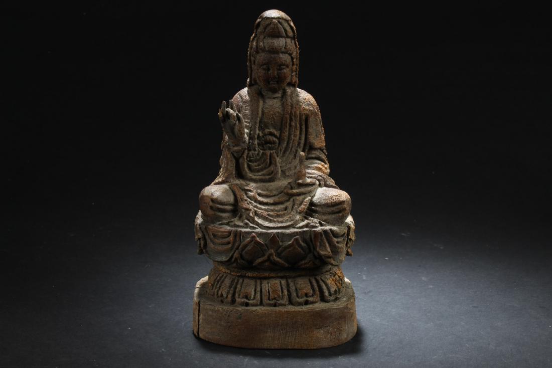 Antique Chinese Wood Carved Guanyin Statue: Seated in dhyanasana on a double-lotus throne, left hand holding a water vessel, right hand in mudra, wearing long flowing robe, the face with serene expression. Height: 8.25"