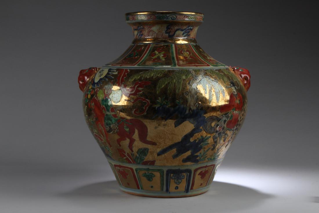 Chinese Porcelain Jar: Flanked by two mythical beast faced handles, of broad shoulders, the vase is decorated with high rank official and enlighted monk travelling outdoors. Height: 14"