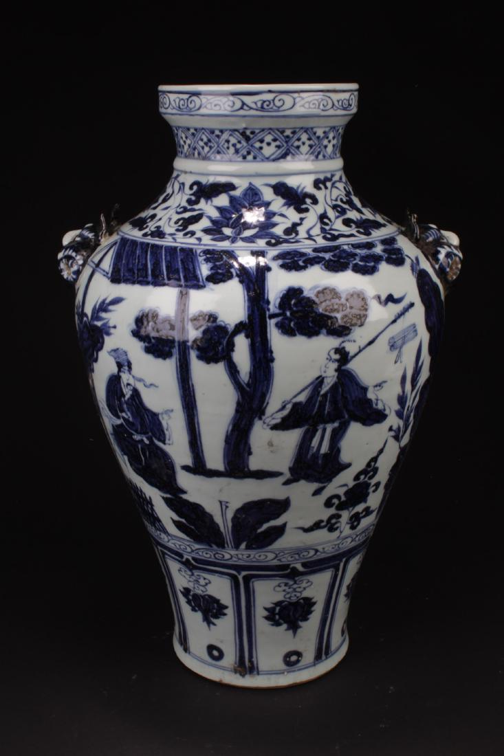 Chinese Blue & White Porcelain Vase: Flanked by two mythical faced handles, the porcelain vase is painted with figures in outdoor scenery. Height: 17.5 "