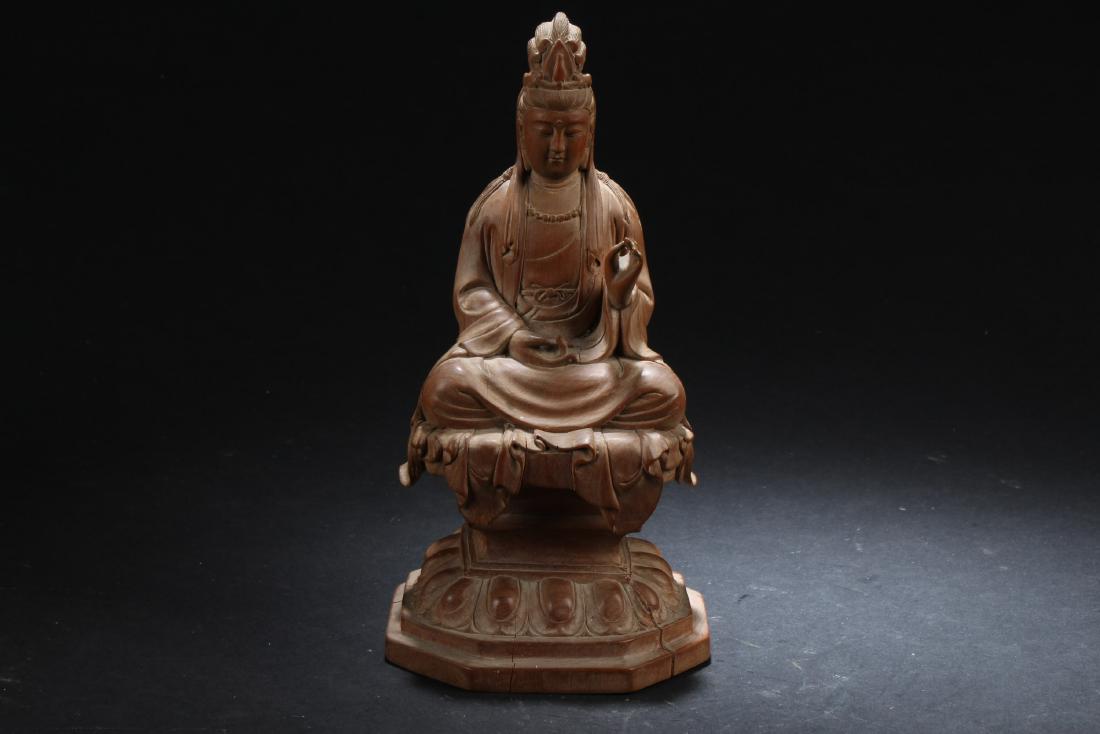 Antique Chinese Wood Carved Guanyin Statue: Seated in dhyanasana on a lotus throne, both hands in mudra, wearing long flowing robe, the face with serene expression. Height: 7.25"