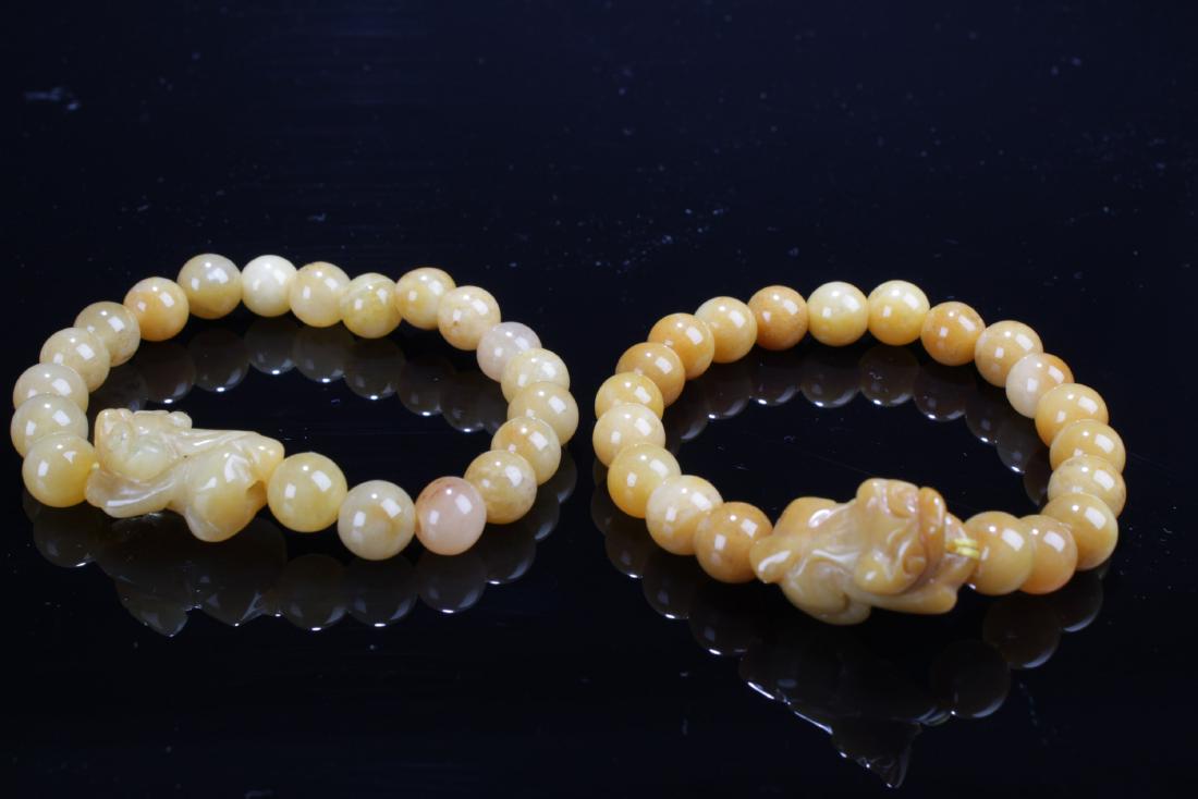A Pair of Chinese Jade Bracelets: A Pair of Chinese Jade Bracelets. Diameter: 0.25" (Bead)
