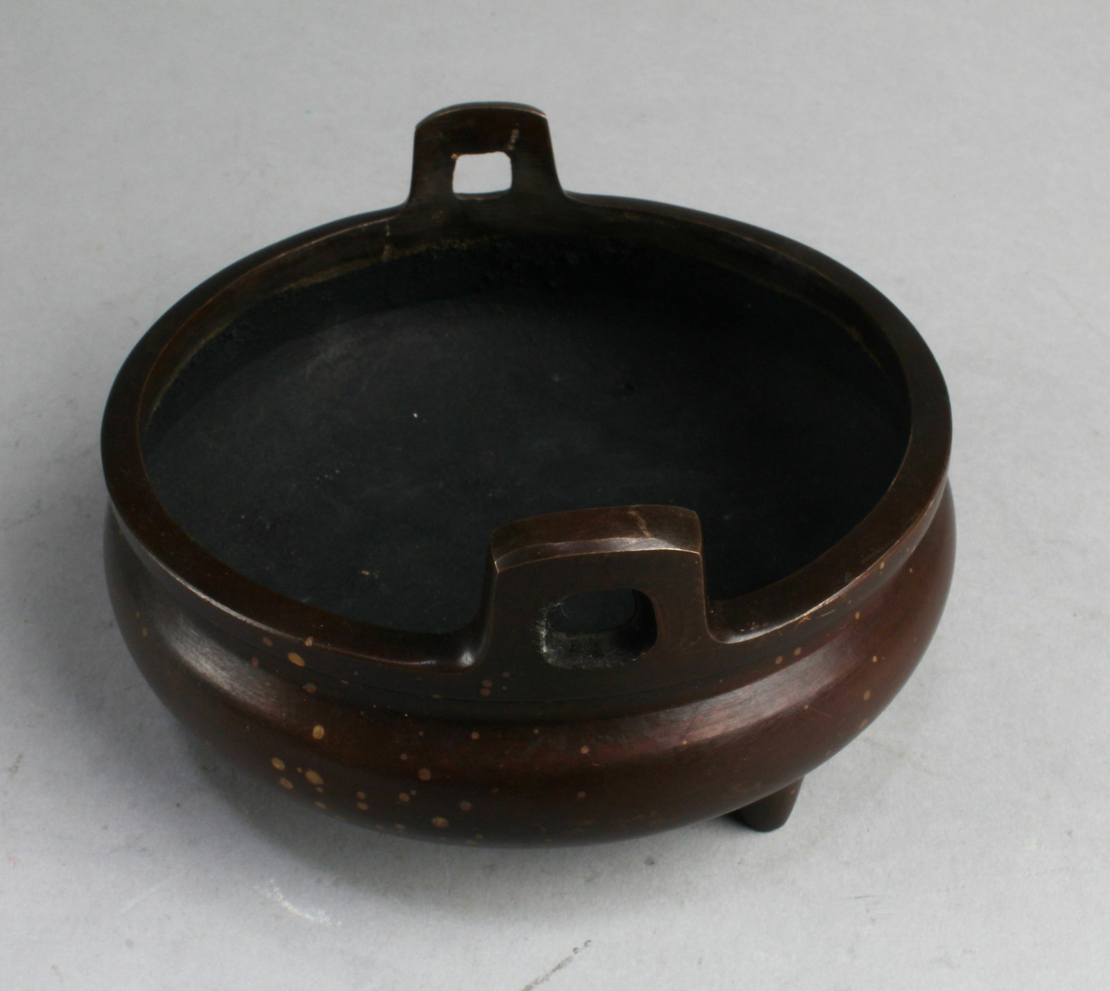 A Bronze Tripod Censer: A Bronze Tripod Censer, flanked by twin handles. 'XuanDe'. Diameter: 6.5"