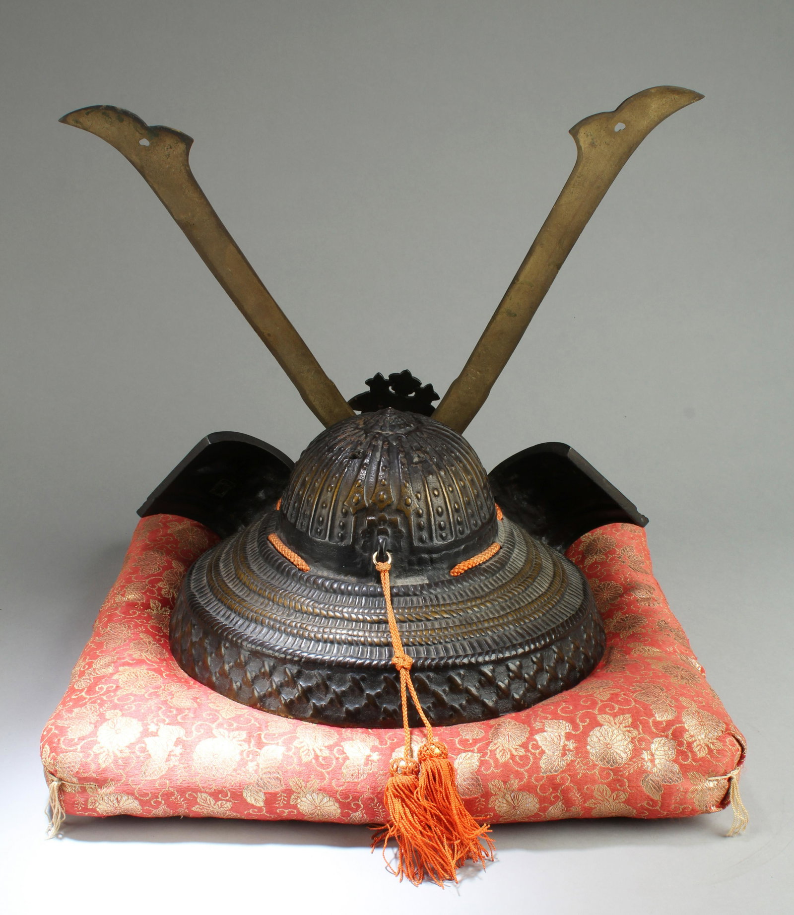 A Japanese Armour Helmet: A Japanese Armour Helmet. Comes with a cushion. Length: 15" Height: 14.5"