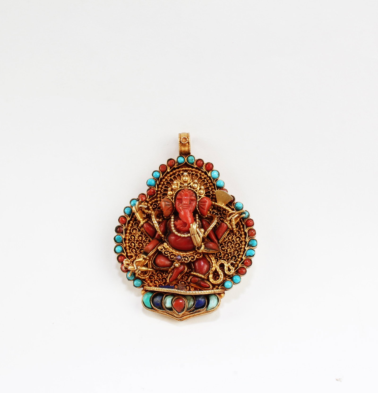An obstacle removing Pendant with a figure of a: An obstacle removing Pendant with a figure of a Ganesha, with gold inlaid, turquoise, and coral stones around and a good luck mantra, Nepal. Height: 2.75"Provenance: Private Collection of Yangki, Cost
