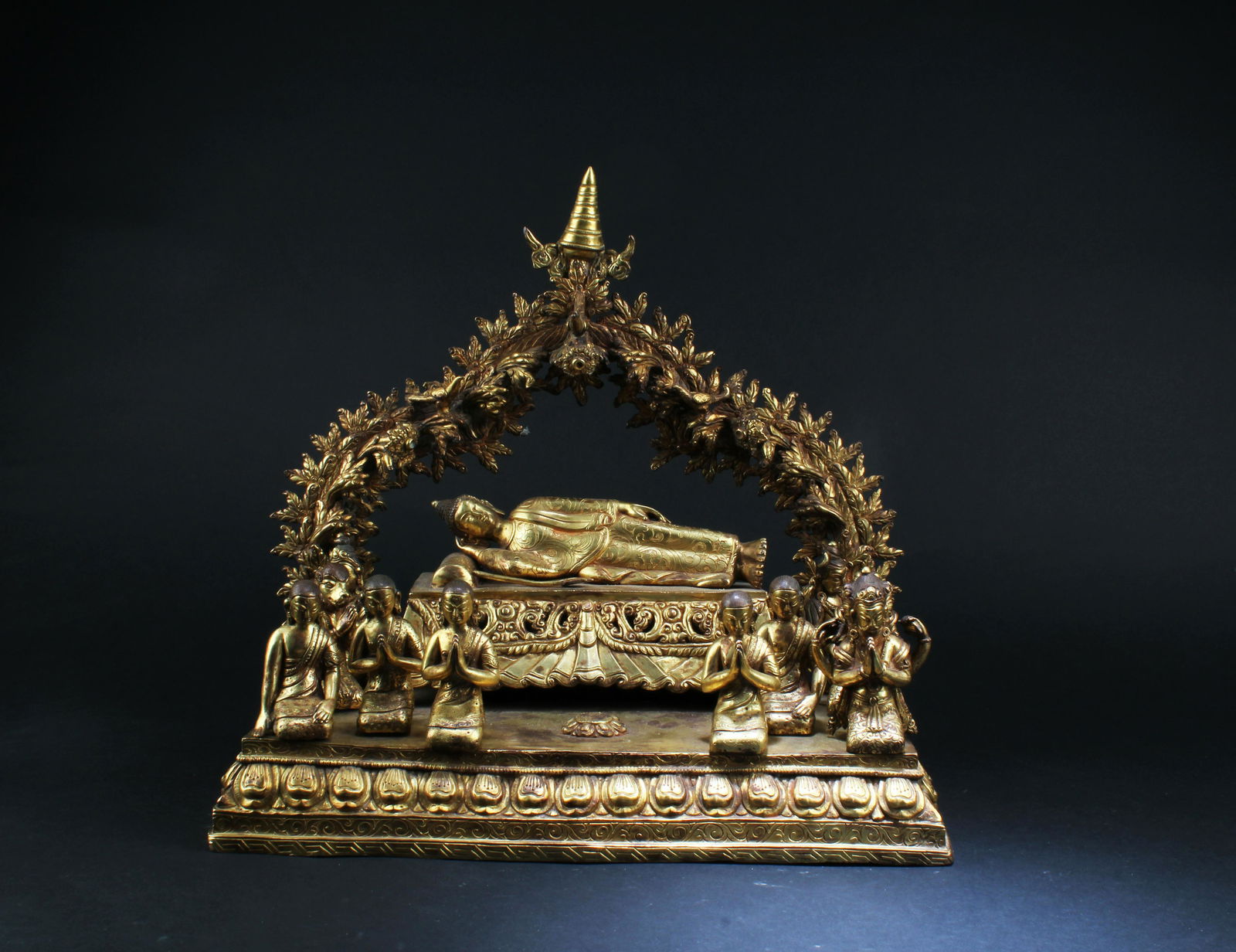A gilt, bronze figure of Buddha at Nirvana with ten (1 of 17)