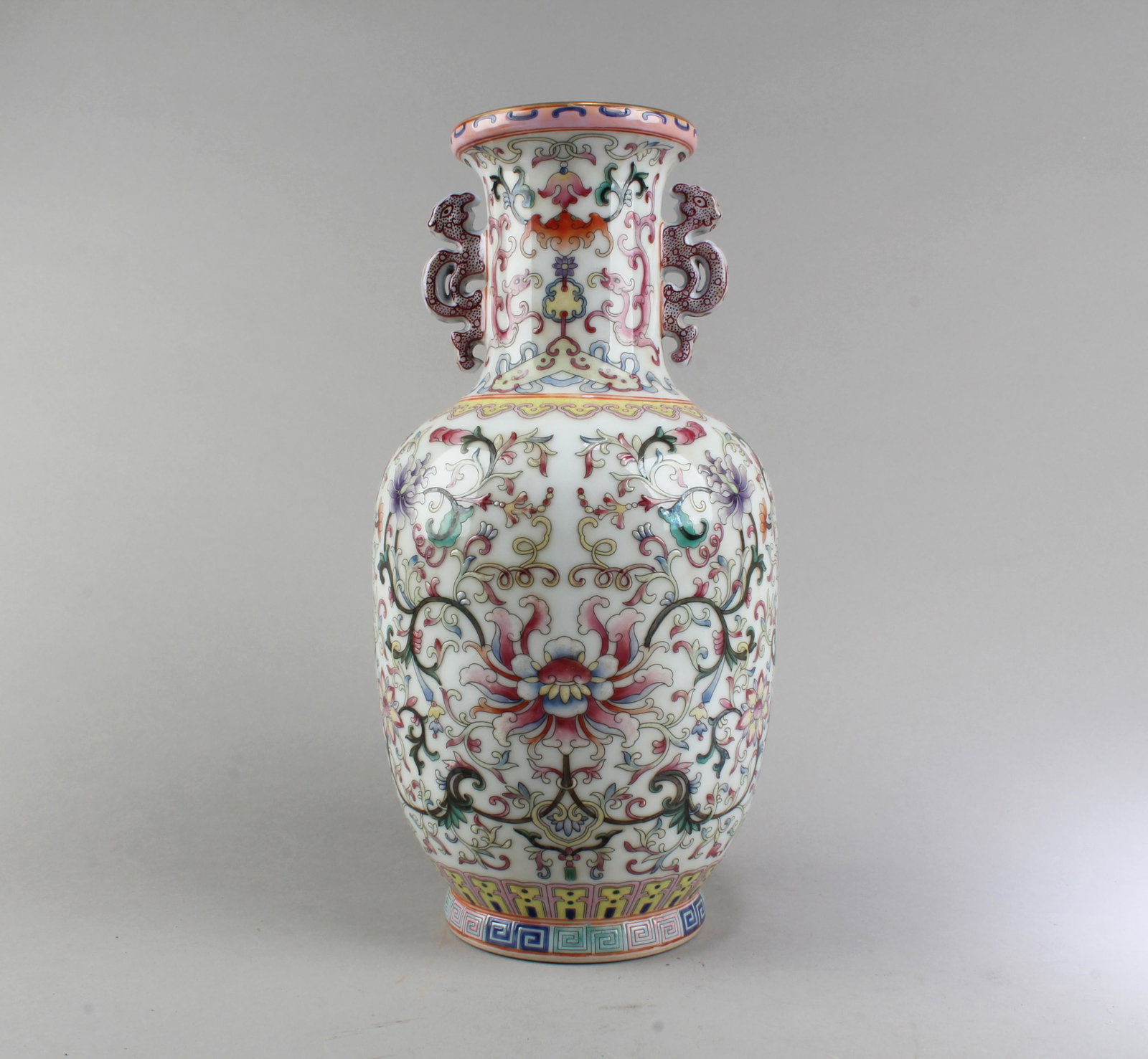 Chinese Porcelain Vase: Chinese Porcelain Vase, flanked by twin handles. 'QianLong' mark at base. Height: 12"