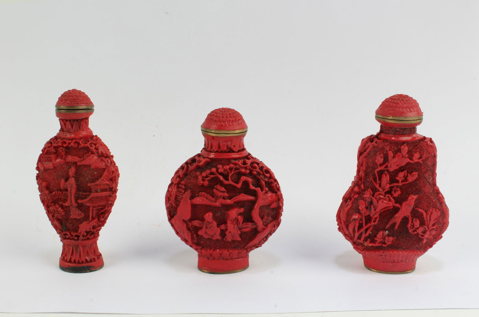A Group of Three Cinnabar Snuff Bottles (1 of 4)