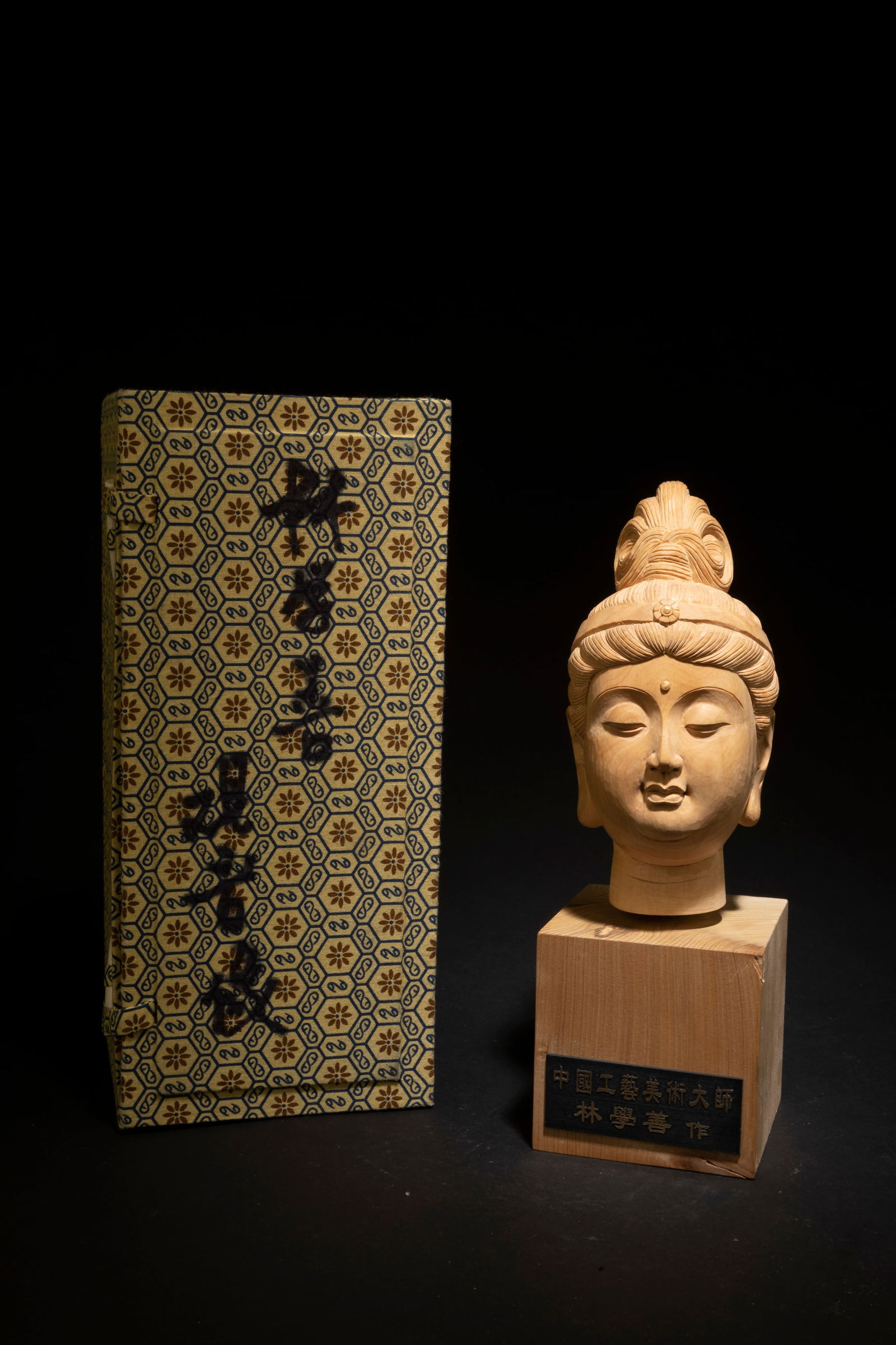 A Carved Wooden Guanyin Head: A Carved Wooden Guanyin Head, by Lin Xue Shan. Comes fitted with a box. Height: 29"